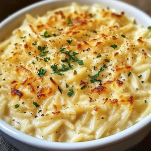 Close-up of creamy orzo pasta with grated Parmesan and herbs