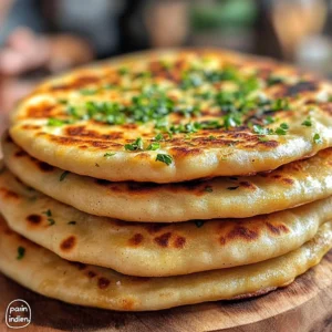 Stack of freshly cooked Indian flatbreads without yeast on a plate, garnished with butter