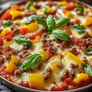 Crustless pizza bowl loaded with cheese, mushrooms, and sausage in a dish