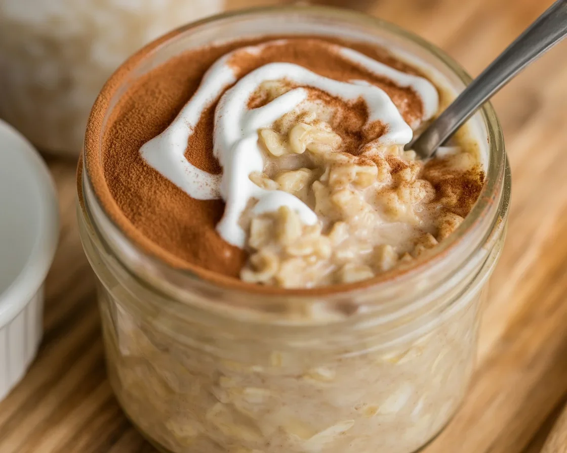 Delicious cinnamon roll overnight oats topped with cinnamon and brown sugar in a jar.
