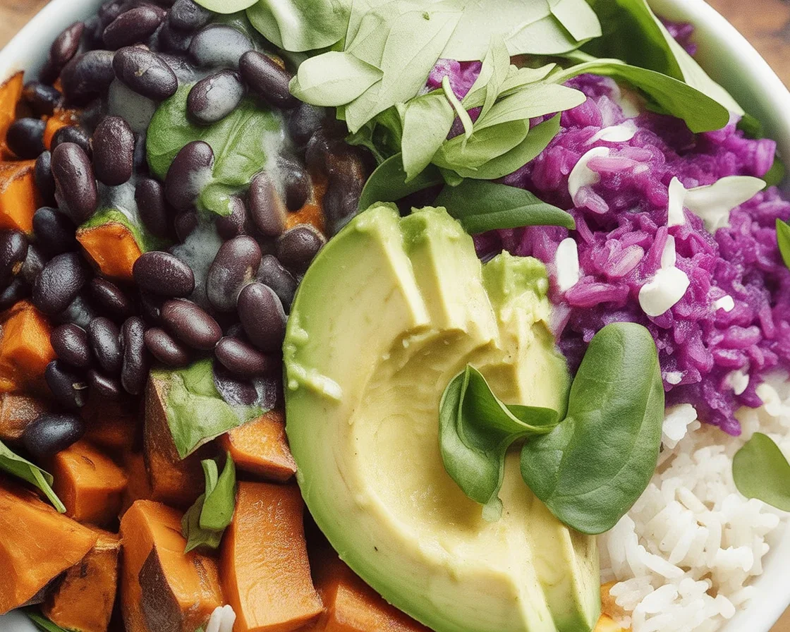 Sweet Potato and Black Bean Bowl topped with Cilantro Lime Yogurt Sauce on a bed of brown rice.