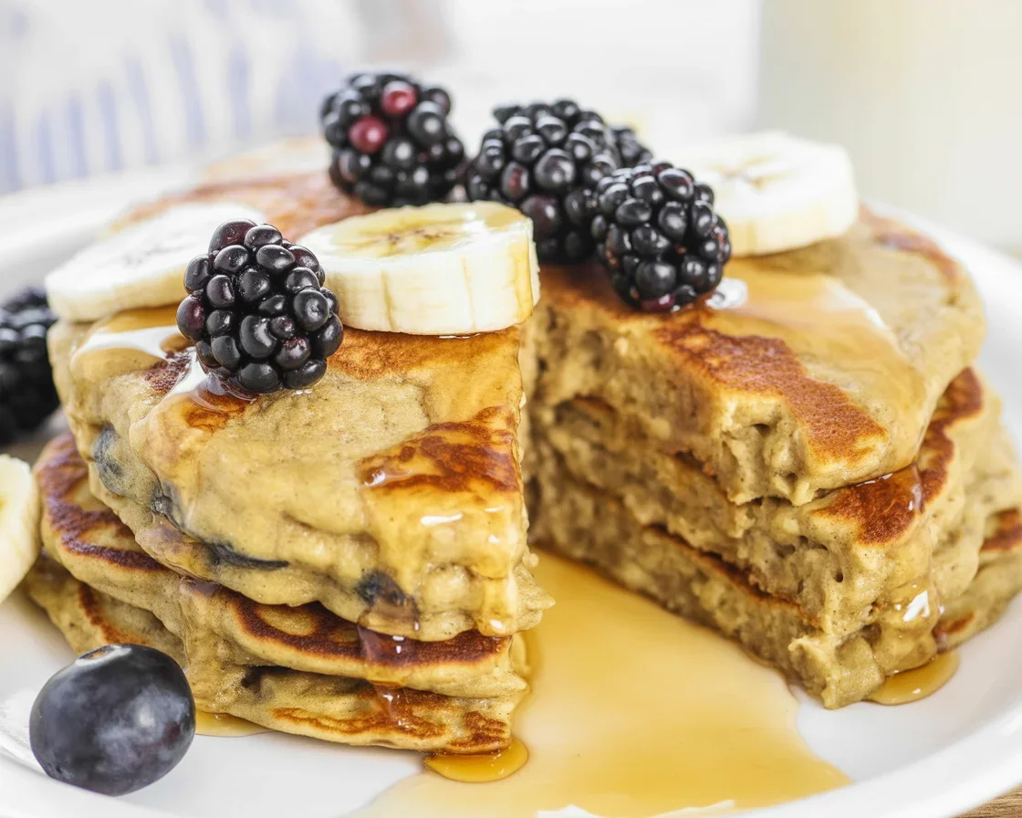 Delicious Vegan Banana Oat Pancakes served with fresh fruit and syrup